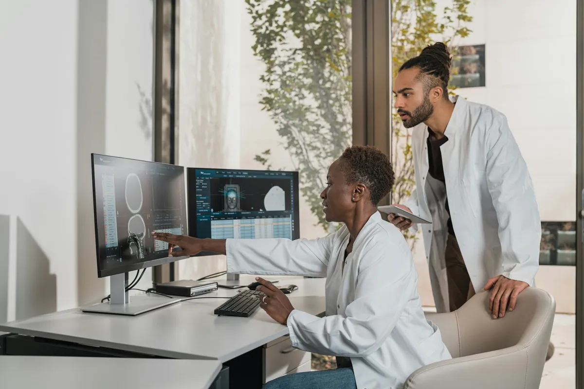 Clinical professionals reviewing imaging on monitors