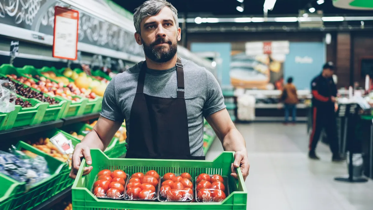 Grocery employee working in a produce department