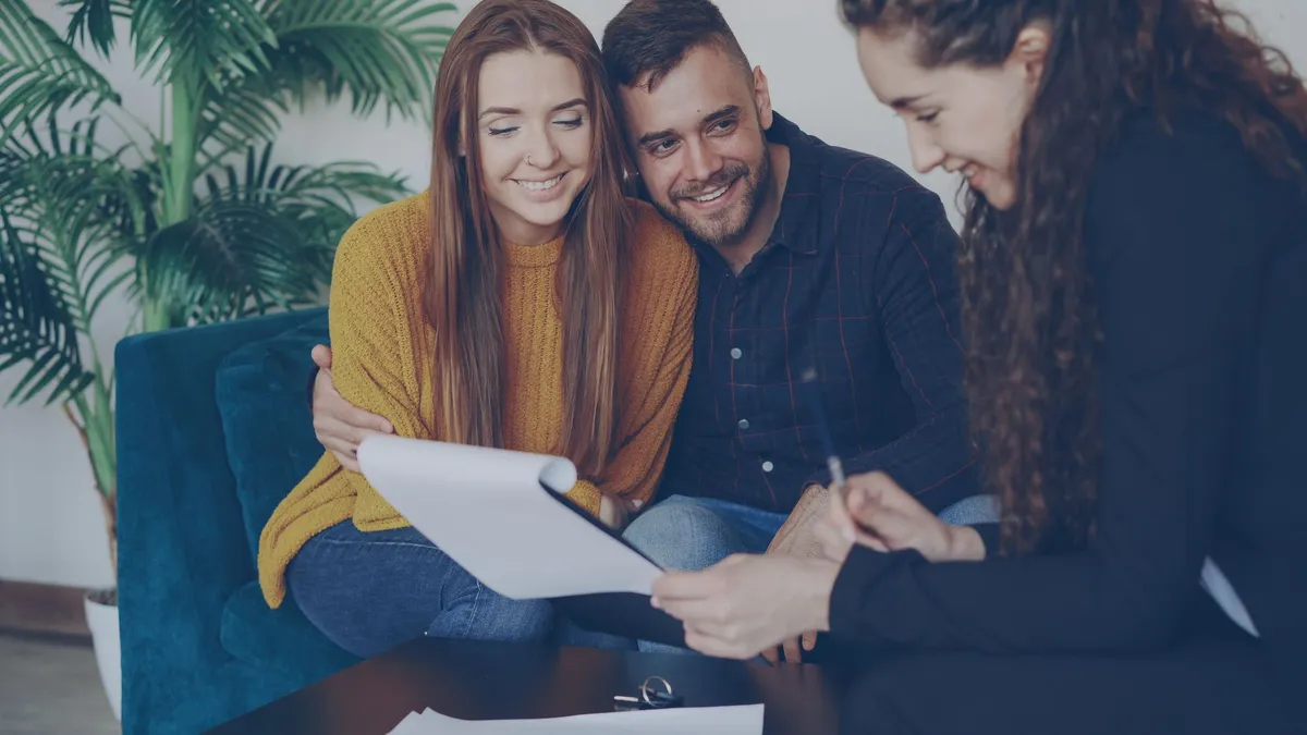 Couple meeting with a financial adviser over paperwork