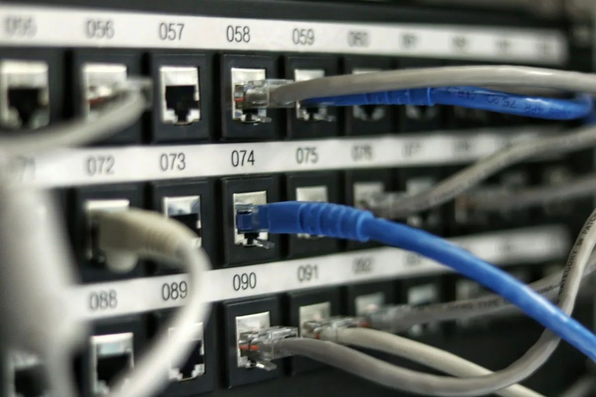 Ethernet cables connected to numbered patch-panel ports.